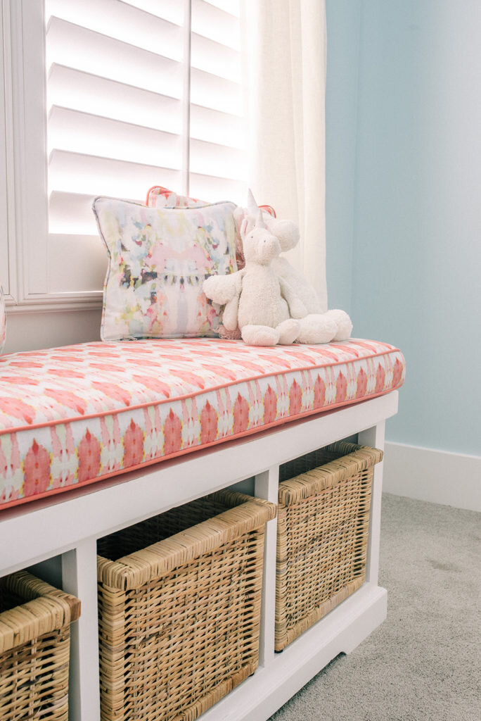 window seat with cushion and baskets