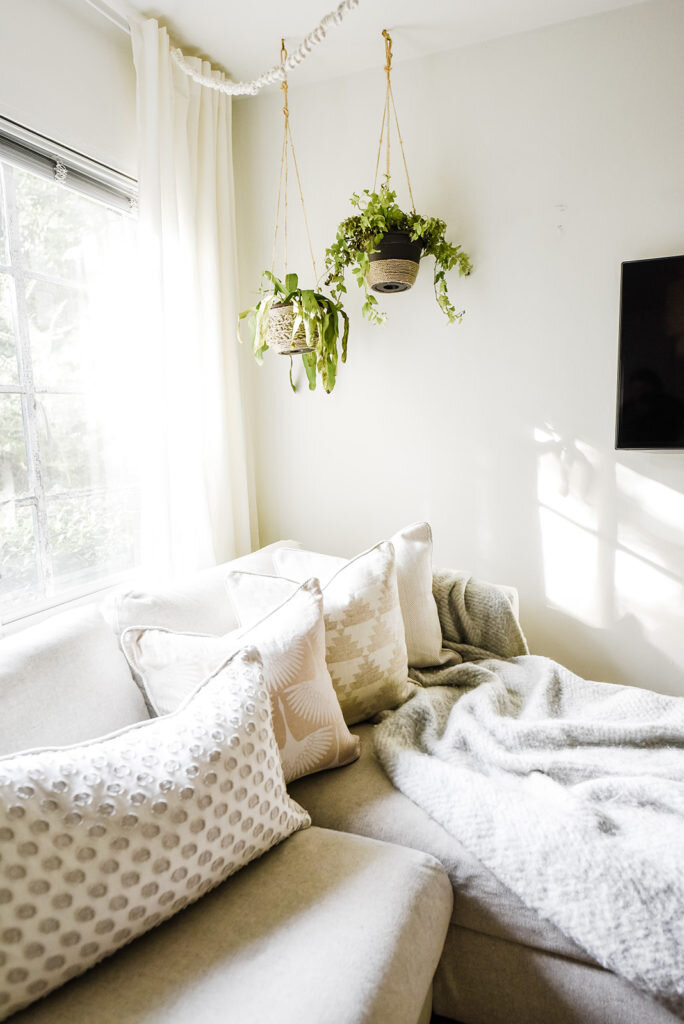 couch with pillows plants hanging atlanta interior photography