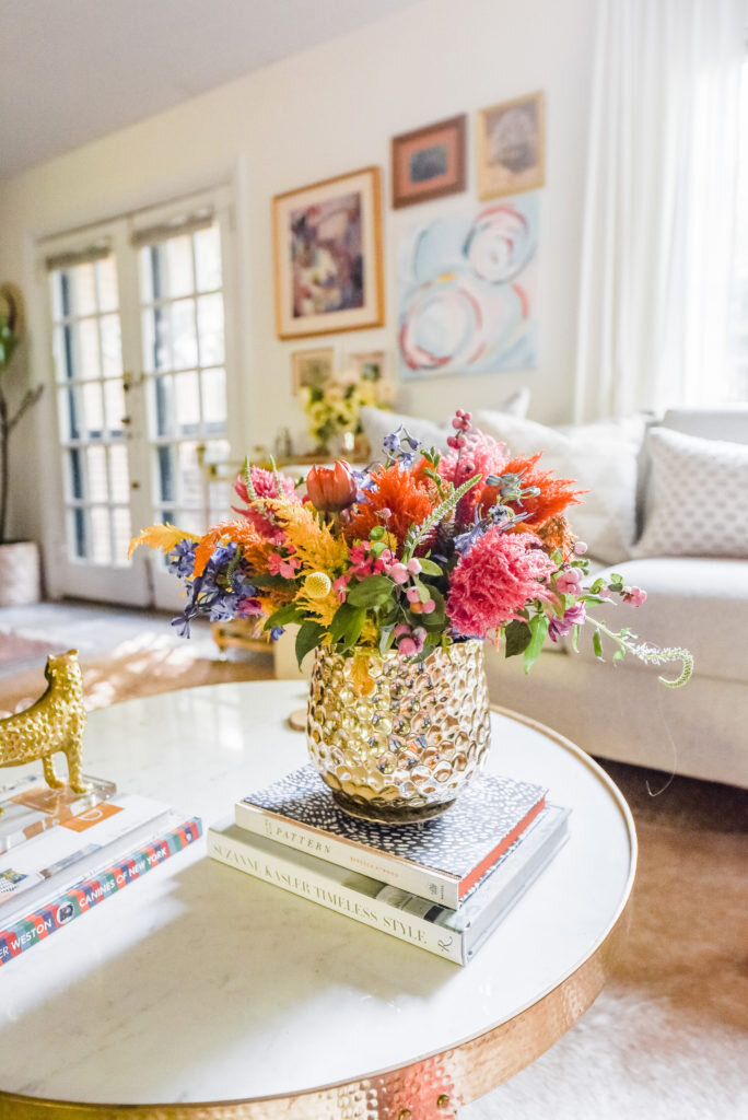 colorful flower arrangement in vase on coffee table