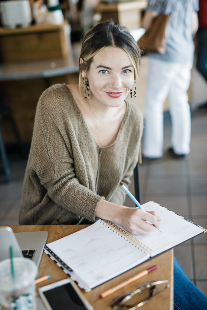 girl in coffee shop with notebook hannah lozano atlanta brand photographer