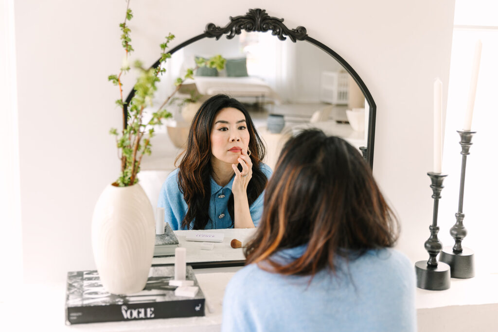 Entrepreneur Applying Makeup in Vanity Mirror - Beauty Brand Photoshoot