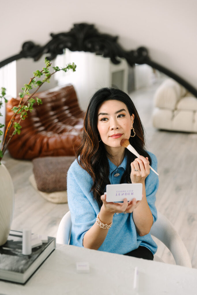 Beauty brand founder applying powder makeup with a brush during a prof