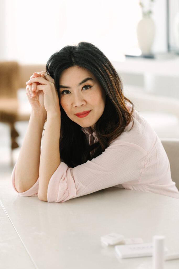 Portrait of a beauty brand founder during a professional brand photoshoot in a bright, serene setting.