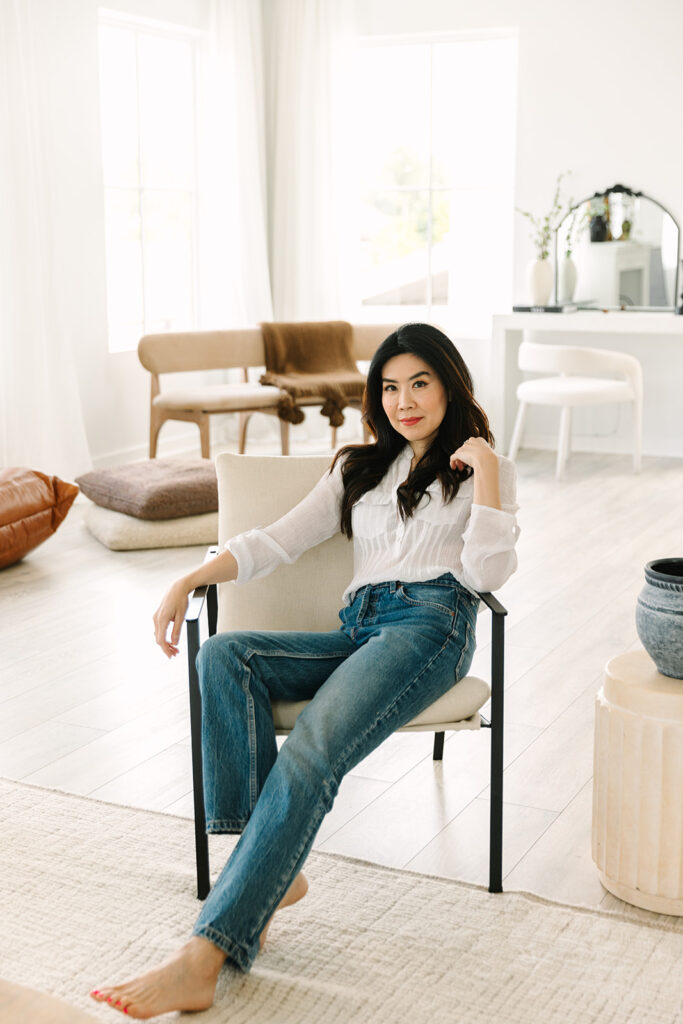 Entrepreneur sitting comfortably in a modern, cozy home office during a brand photoshoot.